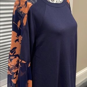 Women’s Long sleeve top/blouse with sheer sleeves.